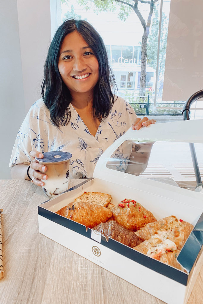 Lifestyle blogger Lisa Favre, munching on delicious croissants by Hazukido Toronto